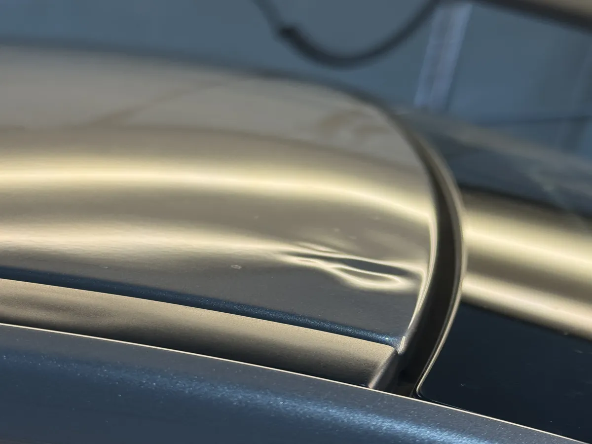 Dent in a car roof before repair
