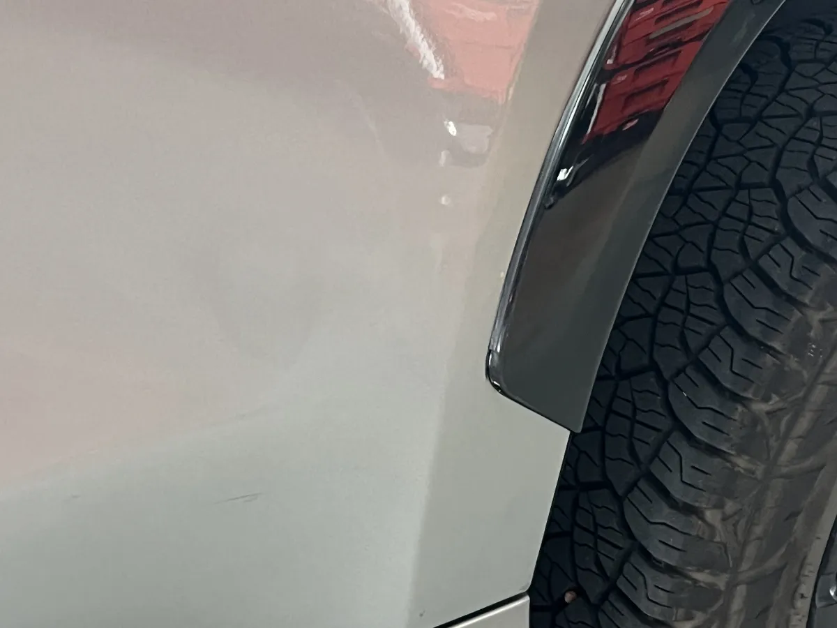 The same rear door after paintless dent repair, dent removed