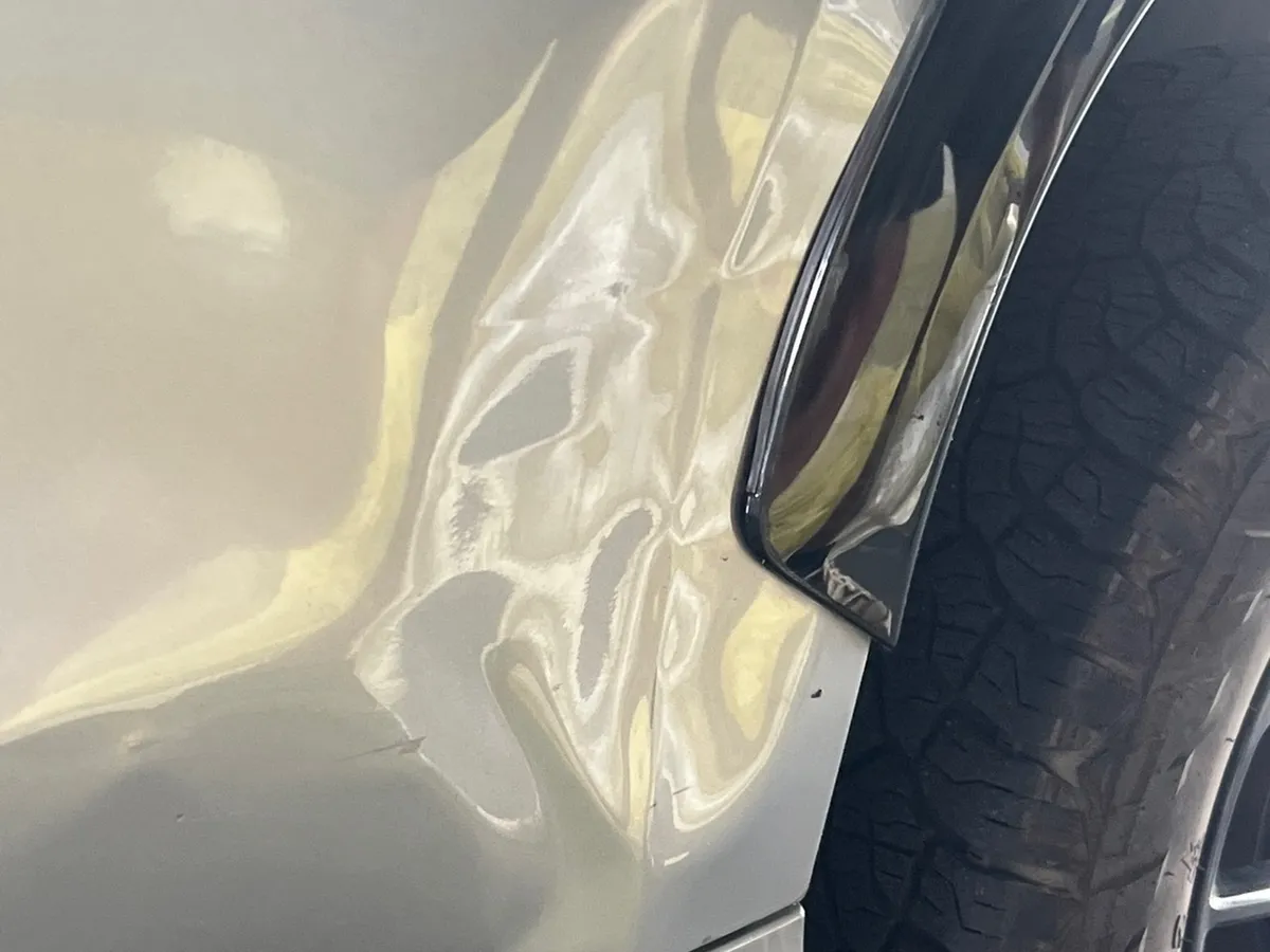 Dent in a rear door before repair